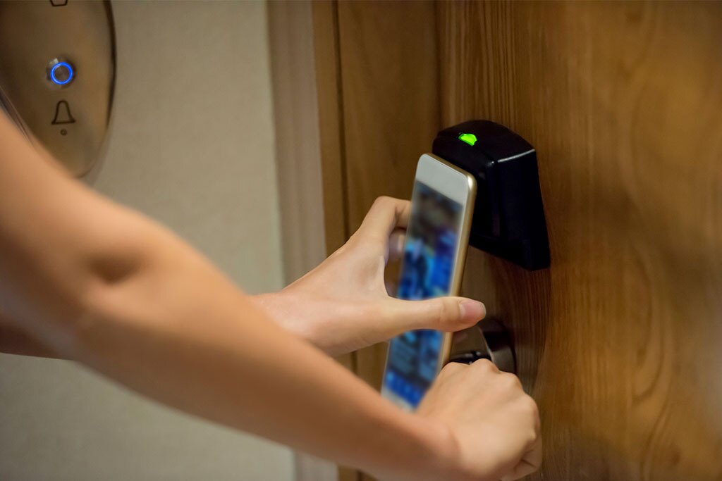 person using a hotel digital key to access room