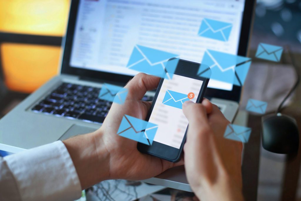 Person receiving and sending emails via phone